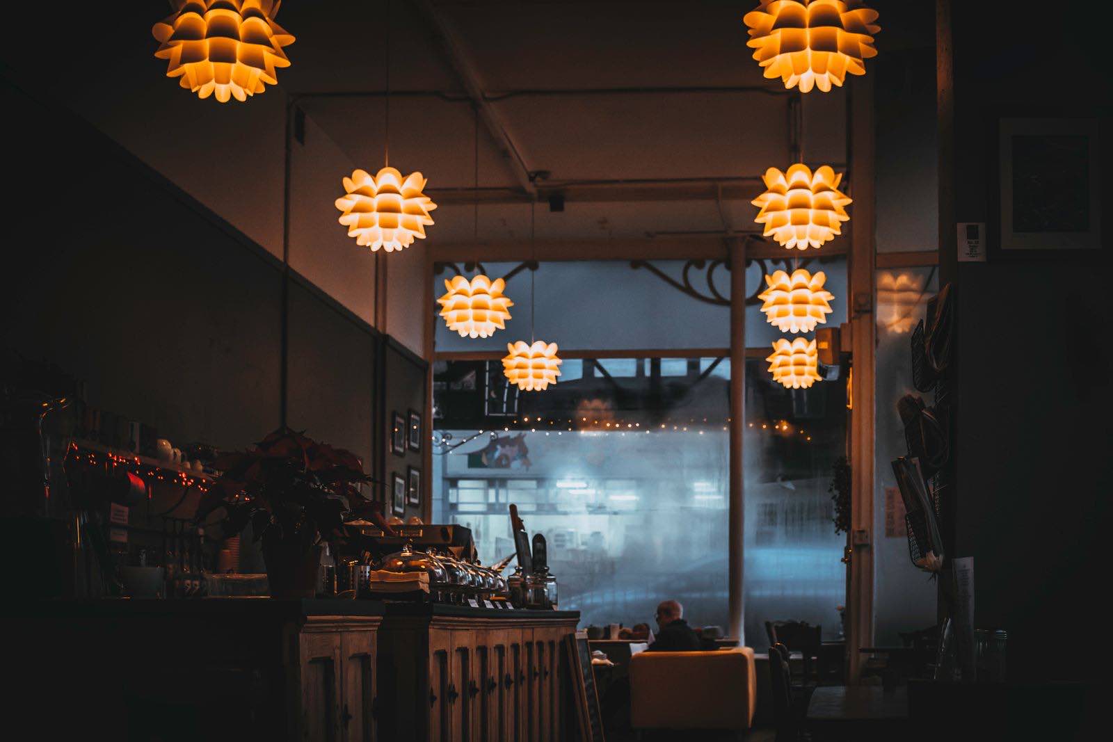 A candlelit dining room, tables laid