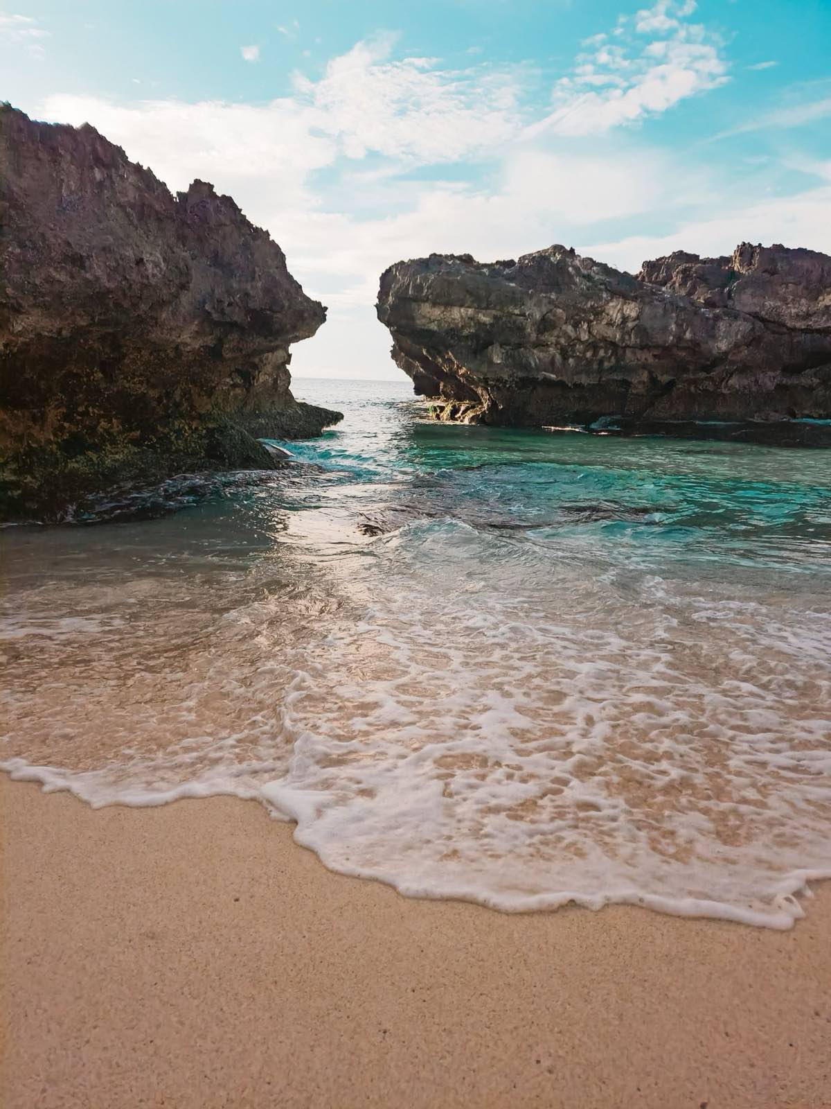 A quiet cove of clear water between rocks