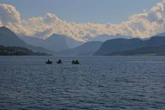 Small boats lying at anchor in a still fjord