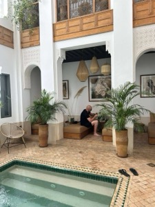 A traditional riad courtyard with tiled floor and cushioned seating